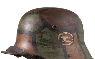 A camouflage steel helmet M 16 with machine gun badge