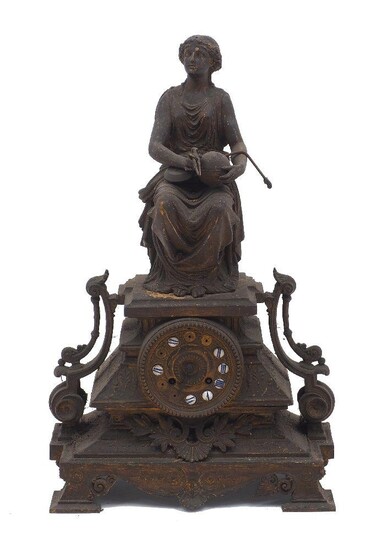 A cast iron mantle clock, 20th Century, the case of architectural stepped plinth form with scrolling lyre handles, surmounted by a seated greco-roman female figure and raised on four feet, the cast iron dial set with enamel roundels painted with...