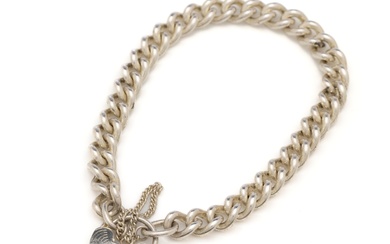 A heavy, 27.4g, sterling silver curb link bracelet with heart clasp and safety chain, L: 19.5cm x 7mm