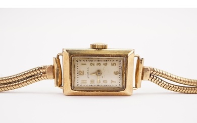 A ladies 9ct gold cocktail watch, by Shield. Snake design br...
