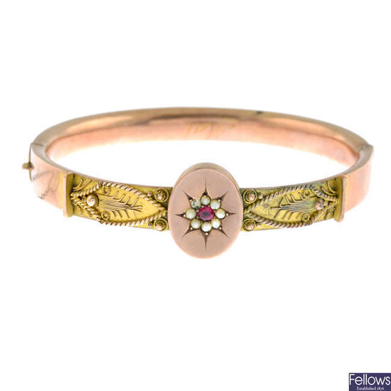 A late Victorian 9ct gold synthetic ruby and split pearl bangle, hinged to the plain reverse.