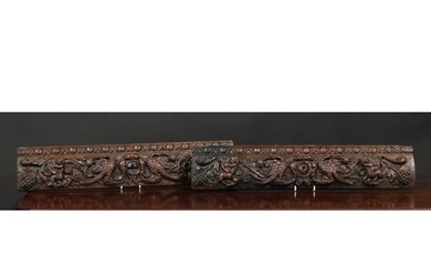 A pair of 17th century oak rectangular panels, each carved w...