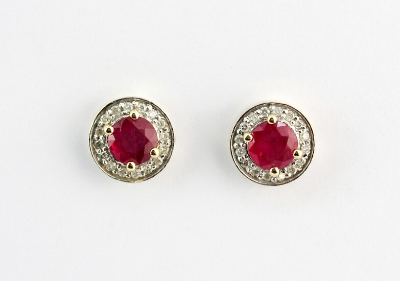 A pair of 9ct yellow gold (stamped 9k) earrings set with round cut rubies surrounded by diamonds, Dia. 1cm.