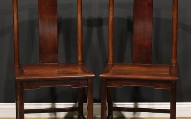 A pair of Chinese hardwood chairs, serpentine cresting rails...