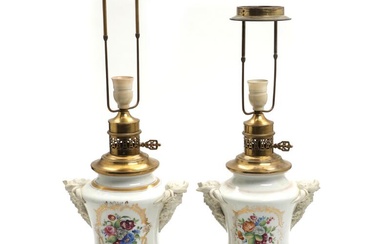 A pair of French porcelain table lamps in the shape of vases,...