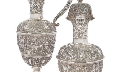 A pair of Victorian silver 'Cellini' style ewers by Robert Garrard II, London, one 1867, one with date mark rubbed, of ovoid form, the body of each ewer cast in relief with various animals, birds and masks and raised on a stepped circular foot, the...