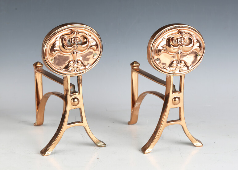 A pair of early 20th century Arts and Crafts coppered and irons with cast foliate decoration, height