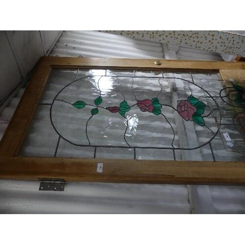 A stained glass Door, in pine frame, with rose design in pin...