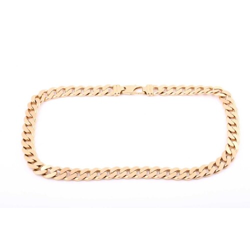 A yellow metal 24 inch long heavy curb link necklace, stampe...