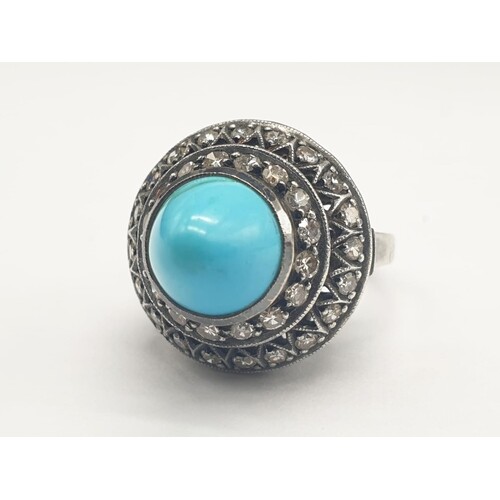 AN ANTIQUE SILVER RING WITH DIAMONDS AND TURQUOISE IN AN ART...