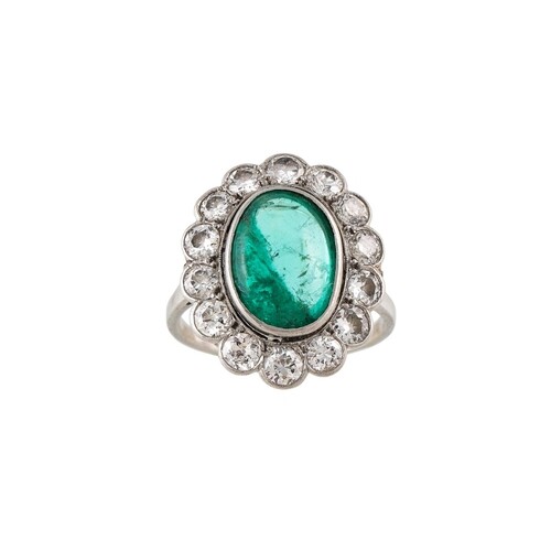 AN EMERALD AND DIAMOND CLUSTER RING, the oval cabochon emera...