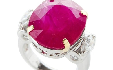 AN UNHEATED MOZAMBIQUE RUBY AND DIAMOND RING IN 18CT WHITE GOLD, CENTRALLY WITH AN OVAL CUT RUBY OF 15.41CTS, IN A SURROUND OF MARQU...