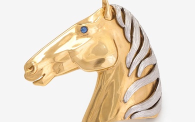 An 18K gold brooch in the shape of a horse head with a cabochon-cut sapphire. Switzerland.