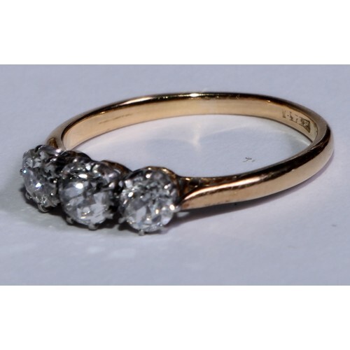 An 18ct gold ring, the platinum bezel set with three brillia...