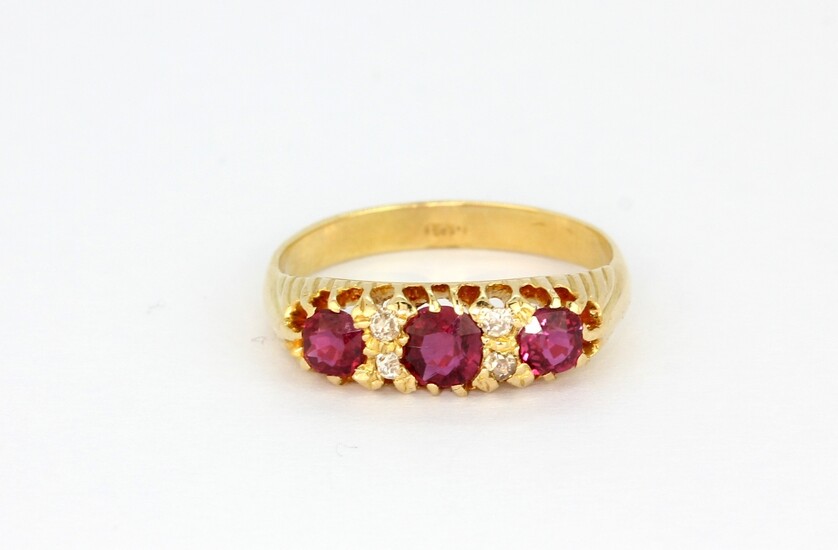 An 18ct yellow gold ring set with oval cut rubies and rose cut diamonds, (P.5).