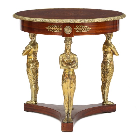 An Empire style mahogany occasional table with bronze mountings. 20th century. H. 76 cm. Diam. 81 cm.