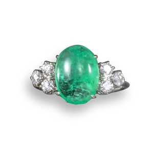 An emerald and diamond ring, the cabochon emerald …