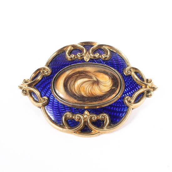 An enamel and yellow metal mourning brooch