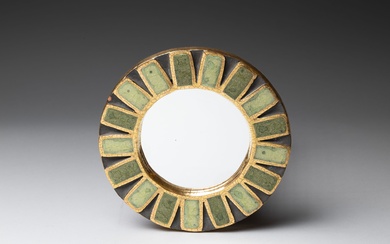 Mithé ESPELT (1923-2020). Miroir circulaire modèle "Engrenage" en céramique émaillée dorée craquelée, amati noir et...