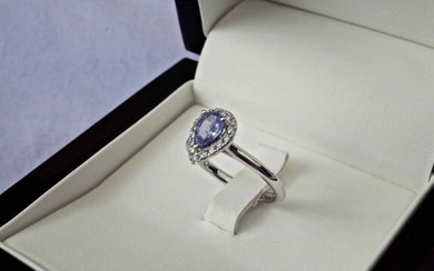 Superb ring, unique piece, in 18 kt rhodium-plated white gold setting a pear-cut Tanzanite, certified 0.71 carat and its entourage of diamonds set in microgrips for a total of 0.16 carat. Size (can be modified) 52 . the ring is engraved and signed by...