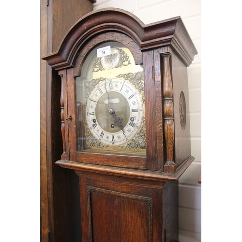 A 20th century oak grandmother clock, with arched dial, reta...