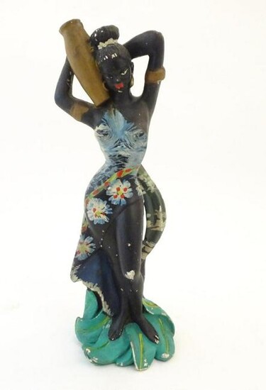 A 20thC model of an African lady in an floral dress