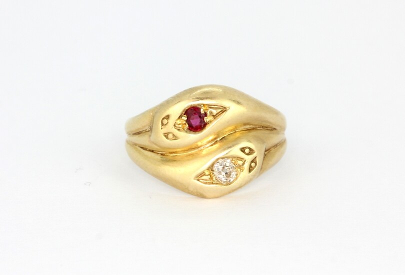 A 9ct yellow gold snake shaped ring set with a brilliant cut diamond and ruby, (N).