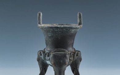 A Chinese bronze elephant trunk-footed tripod censer, Ming dynasty