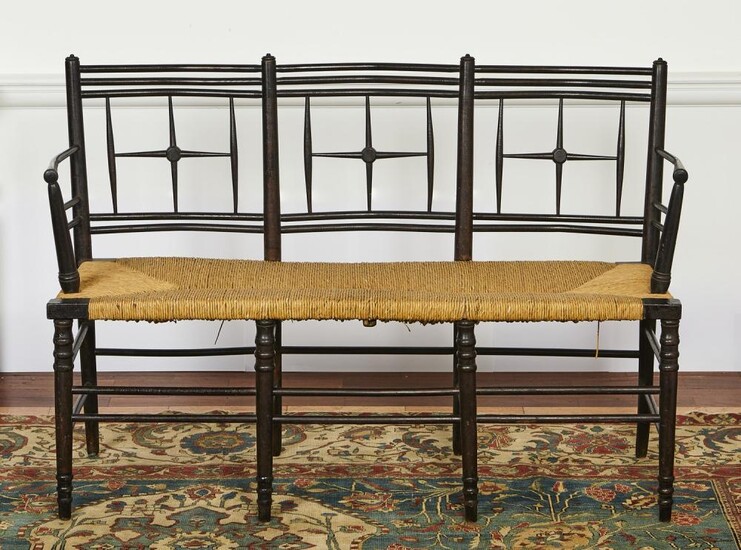 A LATE VICTORIAN EBONISED BEECH SUSSEX THREE SEATER SETTEE, PROBABLY MORRIS & CO