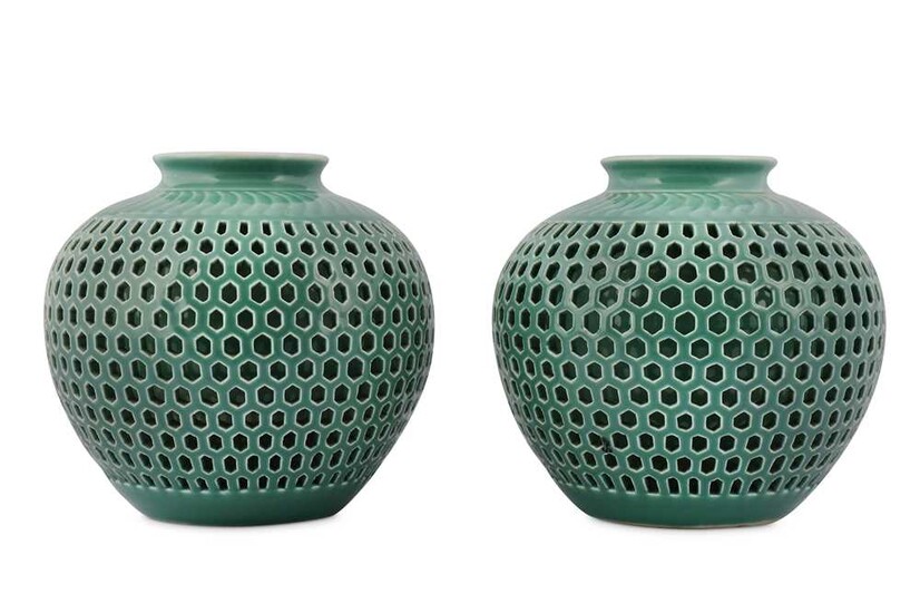 A PAIR OF CHINESE RETICULATED CELADON-GLAZED JARS.