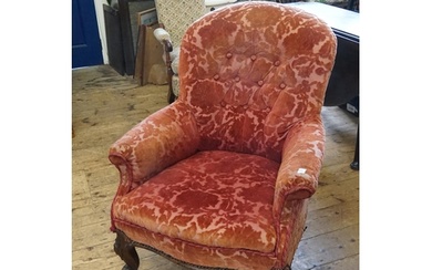 A Victorian Mahogany Framed Easy Chair resting on Shaped Vel...