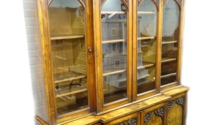 *A Victorian oak and walnut veneered breakfront bookcase, in...