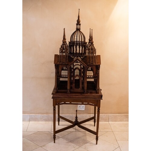 A WALNUT BIRD CAGE ON STAND Modelled as a cathedral above a ...