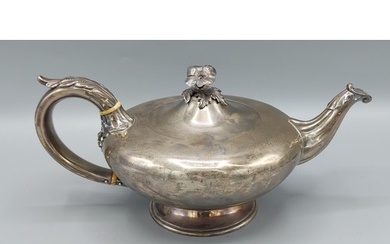 A William IV silver tea pot with embossed decorated handle a...