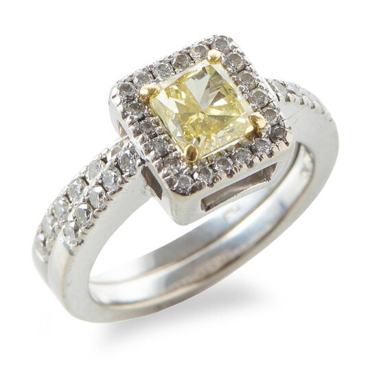 A YELLOW DIAMOND AND DIAMOND RING BY JAN LOGAN