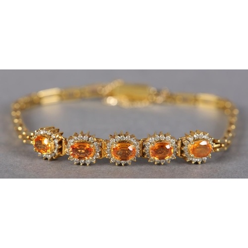 A YELLOW SAPPHIRE AND DIAMOND BRACELET, the oval faceted sap...
