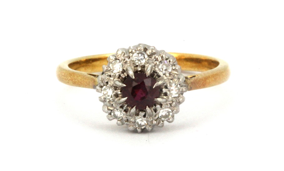 A boxed 18ct yellow and white gold ruby and diamond set cluster ring, (N.5).
