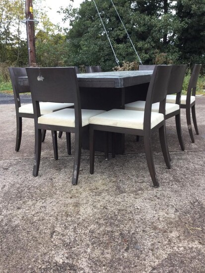 A contemporary rectangular dining table with eight chairs, the...