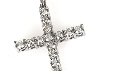 A diamond pendant in the shape of a cross set with numerous...