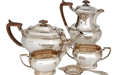 A four piece silver tea set, Sheffield, c.1960, Cooper Brothers & Sons, of panelled rectangular form, the pots with wooden handles and finials, 19cm and 13cm high, together with a silver tea strainer and stand, Birmingham, c.1965, J B Chatterley &...