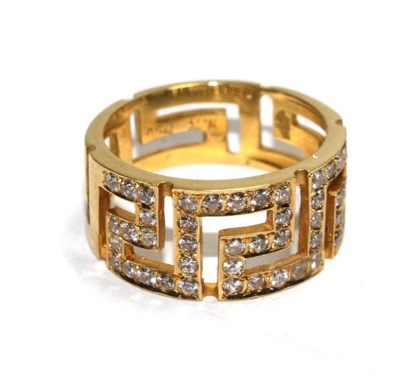 A gold colour metal ring set with diamonds in the form of a ...