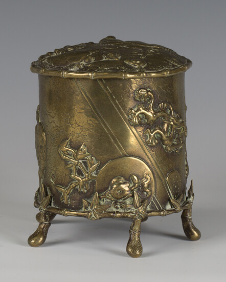 A late Victorian Aesthetic Movement cast brass tobacco jar and hinged cover, decorated in relief wit