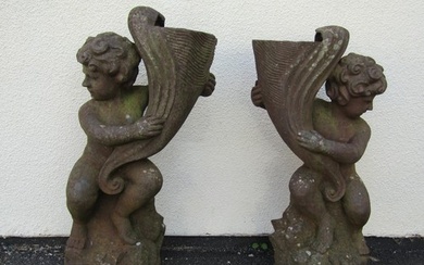A matched Victorian symmetrical pair of figural weathered ca...