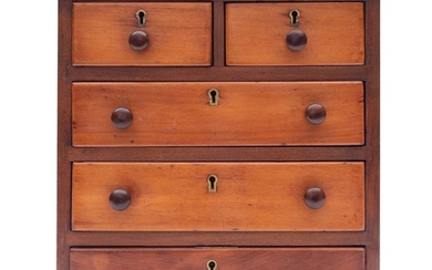 A miniature walnut chest of drawers, early 20th century; the...