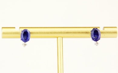 A pair of 18ct white gold sapphire and brilliant cut diamond set stud earrings, L. 1cm. With plastic backs.