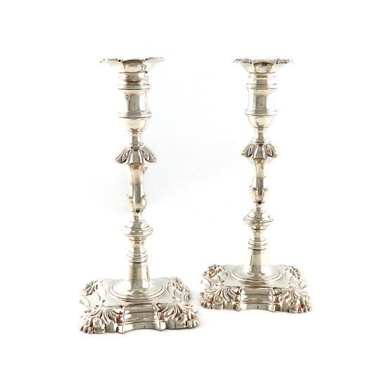 A pair of George III cast silver candlesticks