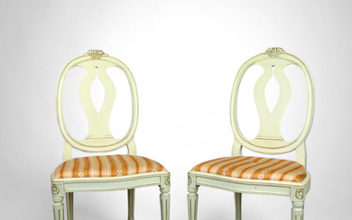 A pair of Gustavian style “Swedish model” chairs, painted and cut wood, upholstered seat, second half of the 20th century.