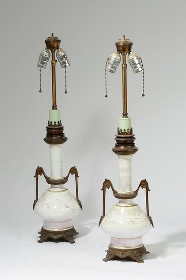 A pair of bronze mounted white glass lamps
