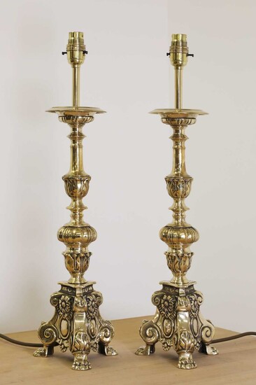 A pair of cast brass altar candlestick lamps