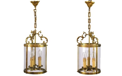 A pair of circular glazed brass hall lanterns.